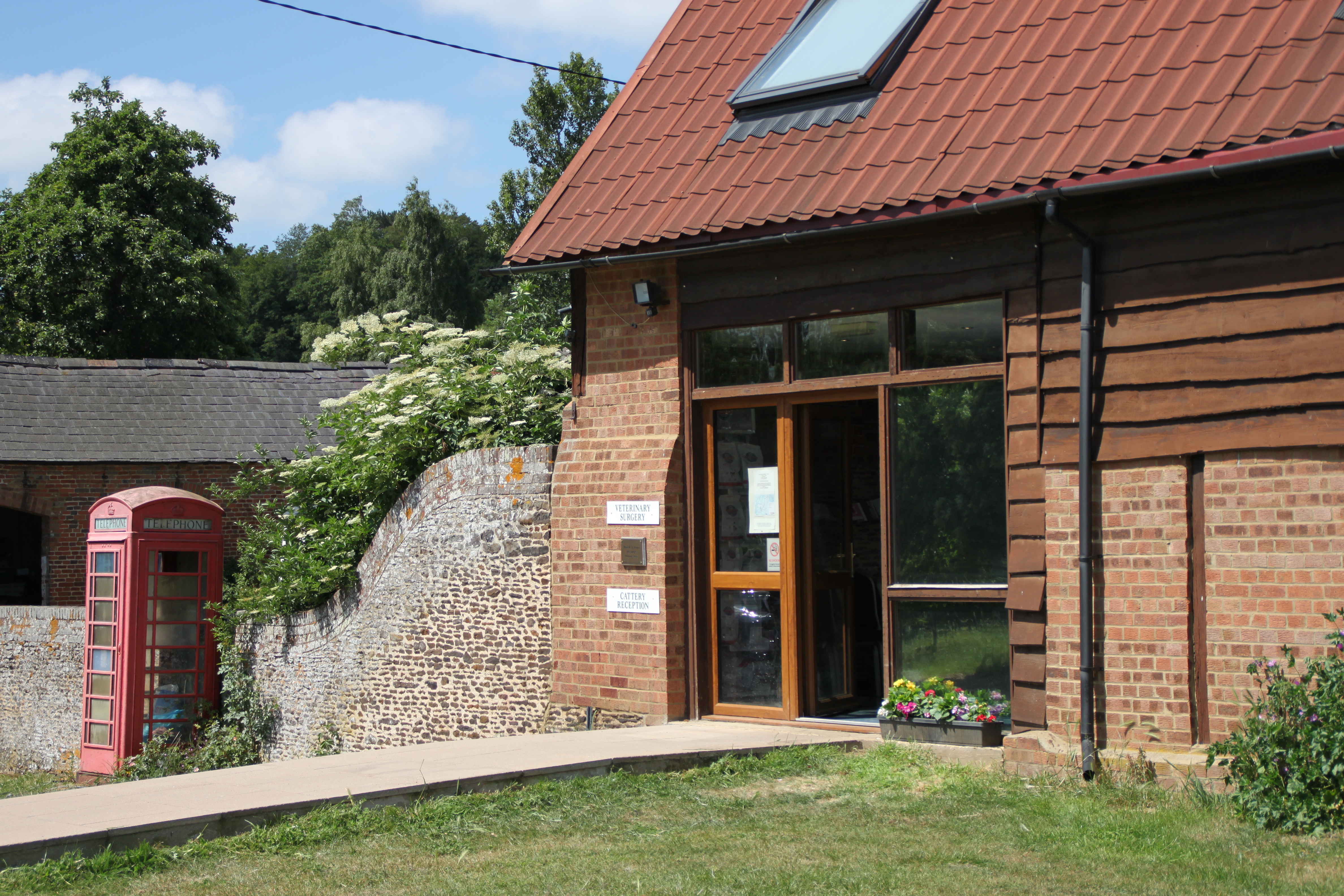 Our practice — a converted barn with red telephone box