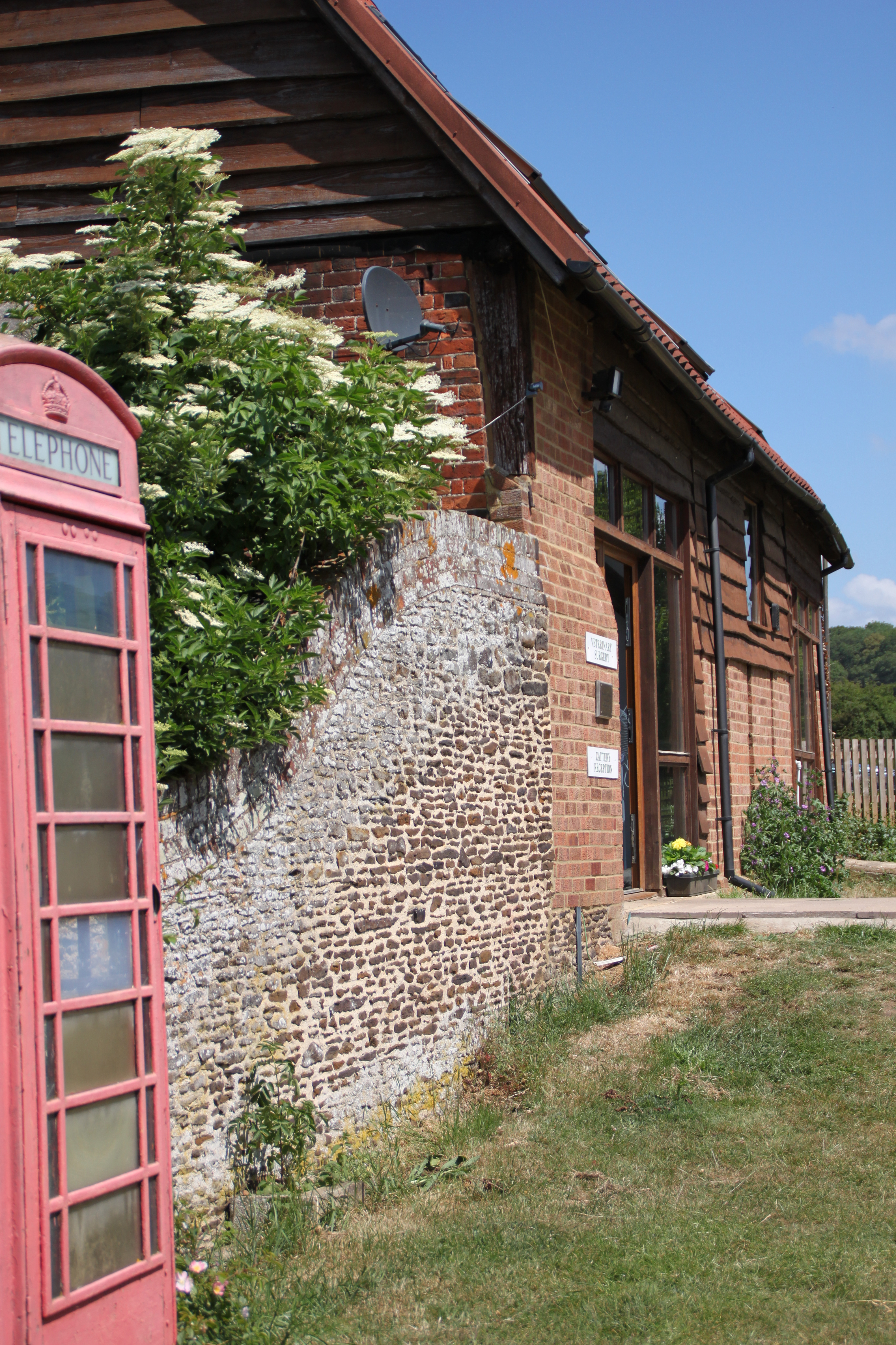 Red telephone box and flint wall at the practice